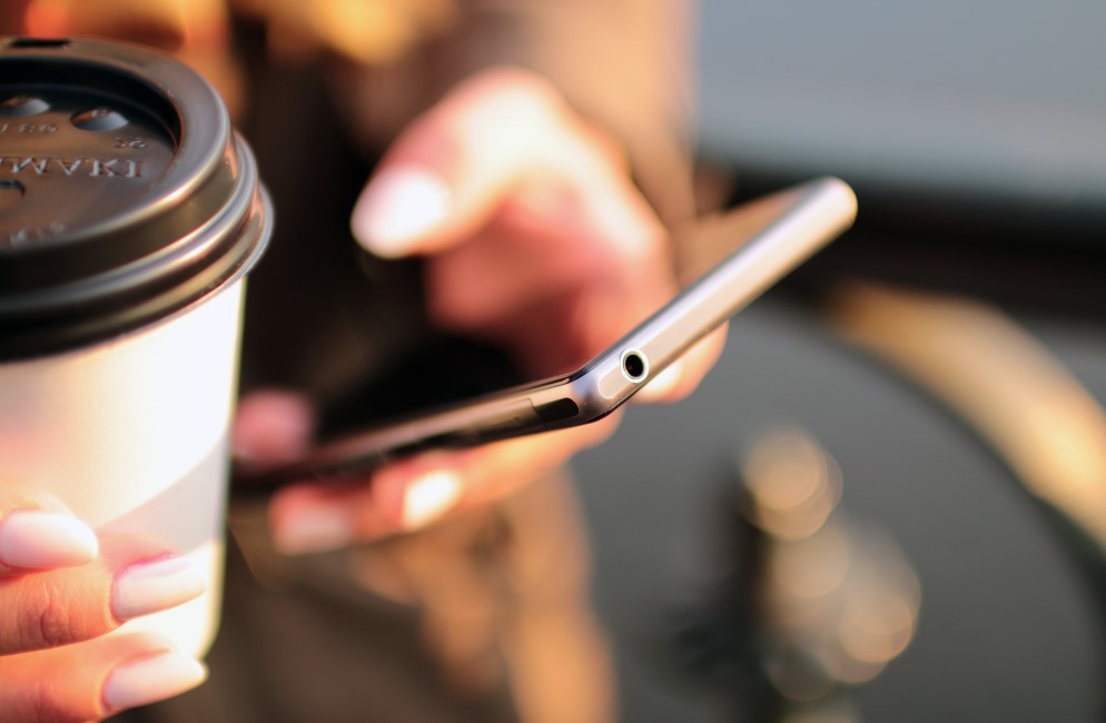 holding coffee cup and phone 2